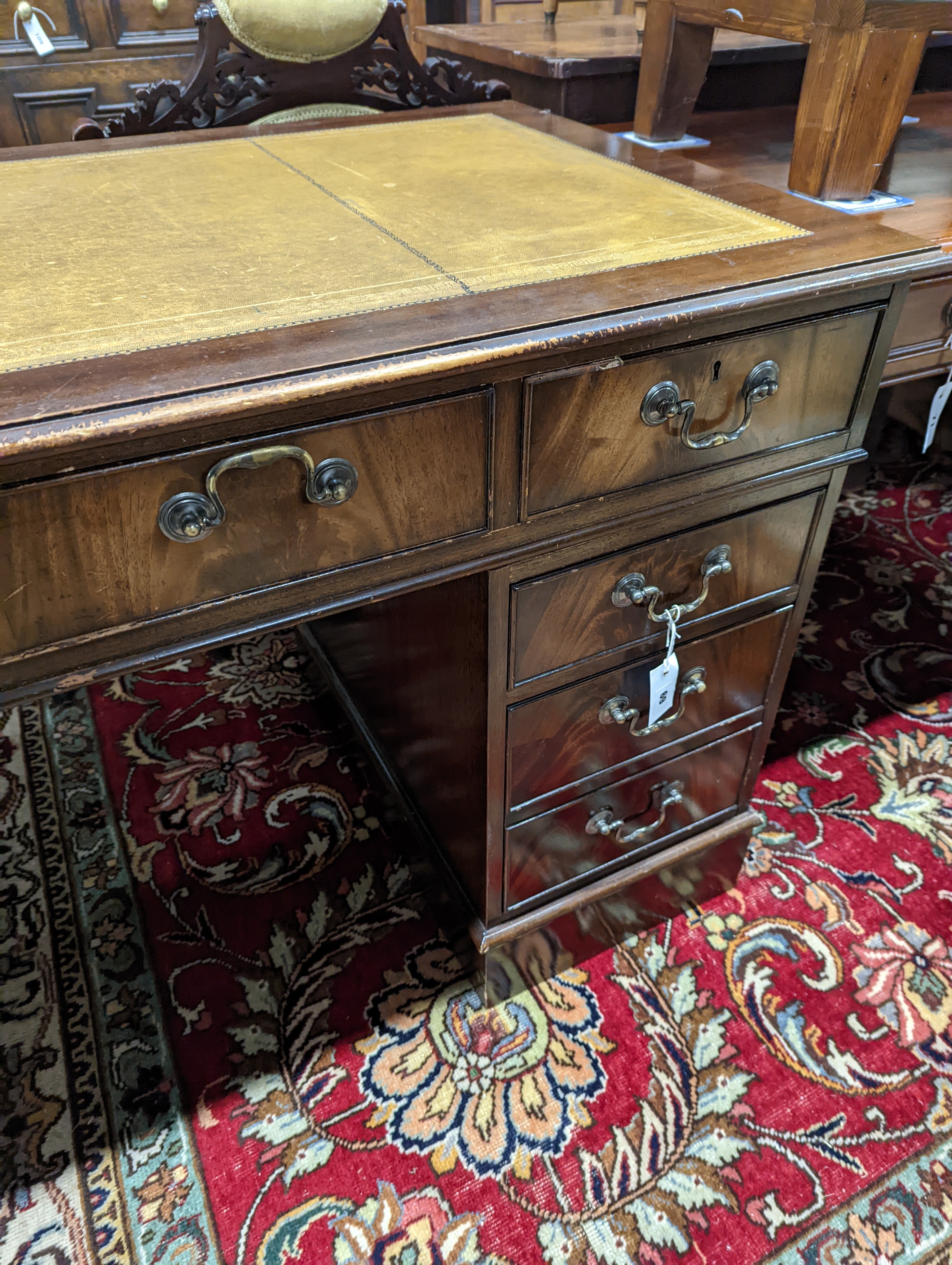 A reproduction mahogany pedestal desk, length 138cm, depth 69cm, height 79cm